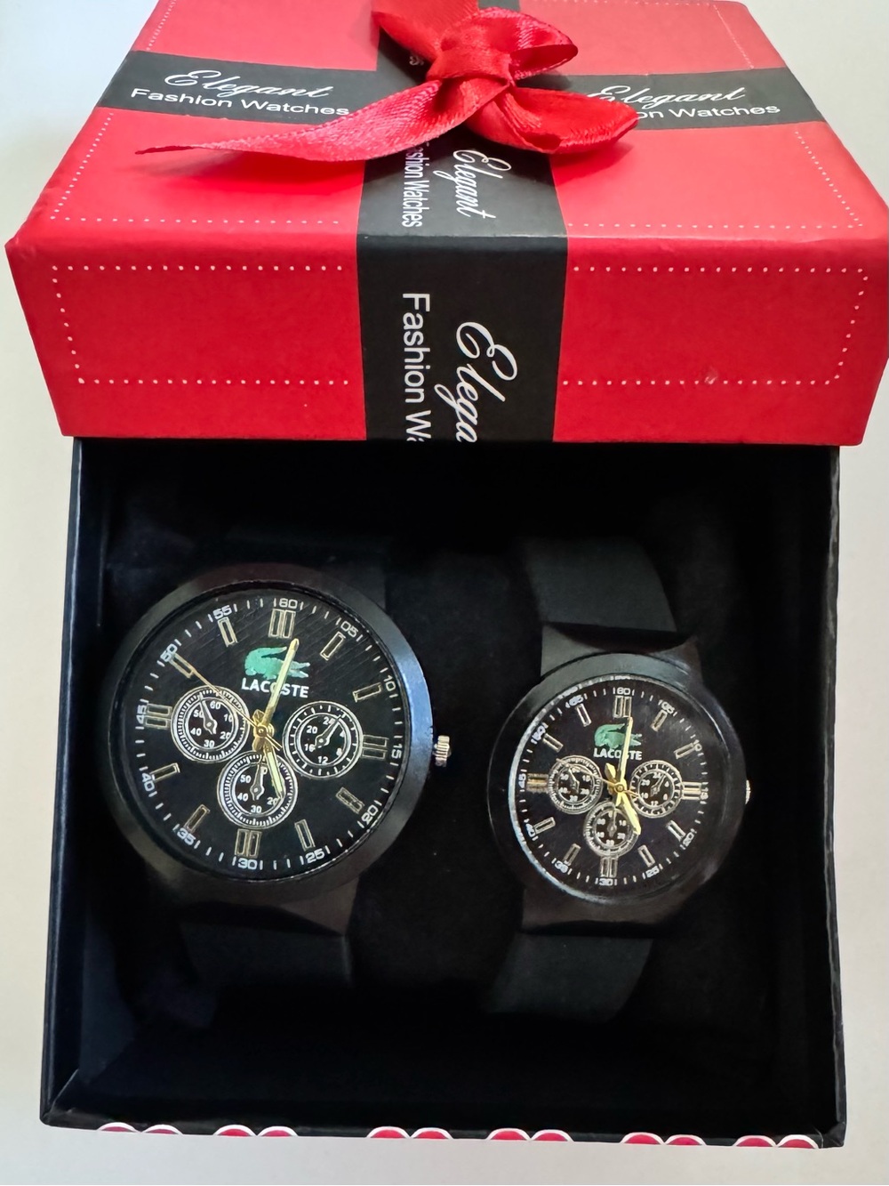 “Lacoste” His & Her Black Watch Set with Gold Accents and Green Logo